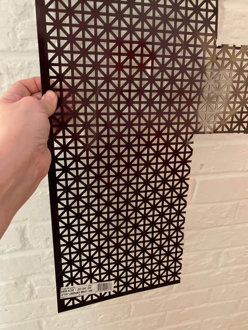This metal is sold in sheets at Home Depot, Lowe's, etc. It comes in several different patterns as well as plain. You don't want plain -- you need the perforations so the candle will get oxygen.